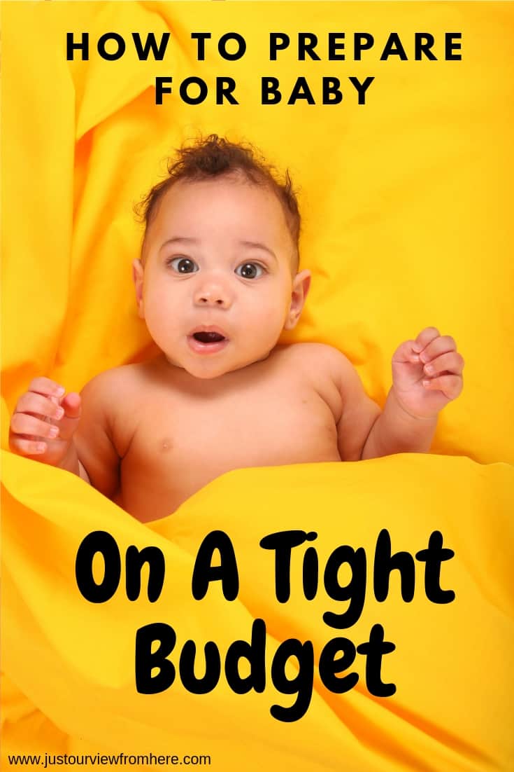 cute african-american newborn baby with a surprised look, text overlay having a baby on a budget