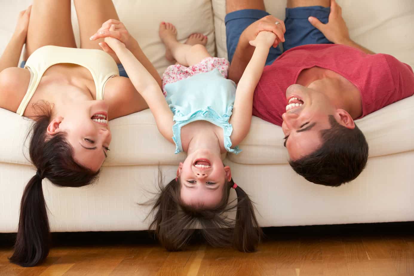 family lying upside down on couch, speech therapy at home tips for parents