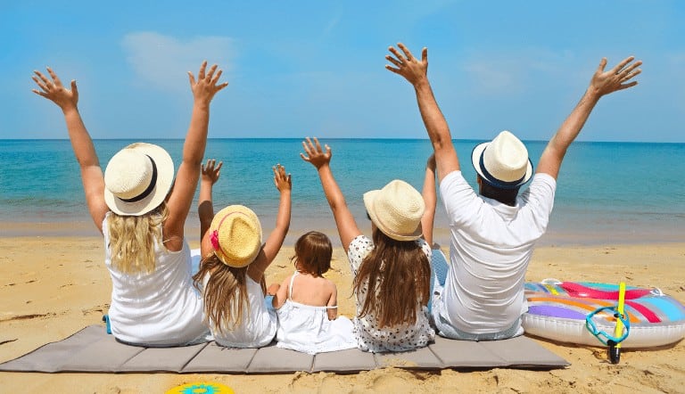 fun cheap family activites for summer, family enjoying beach